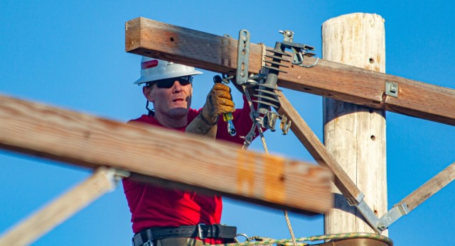 Sgt. 1st Class Mathew Walker, a Soldier assigned to Alpha Company, 249th Engineer Battalion, Prime Power, competes in the Journeyman Pole Climb Obstacle Course during the International Lineman's Rodeo alongside industry professionals at the...