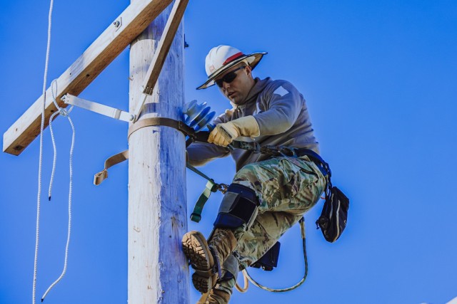 Staff Sgt. Joseph Hak, a Soldier assigned to the Delta Company, 249th Engineer Battalion, Prime Power, competes in the Journeyman Pole Climb Obstacle Course in the International Lineman's Rodeo alongside industry professionals at the National...