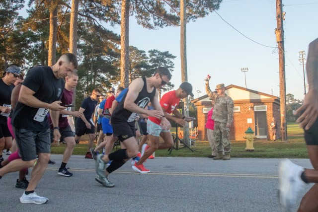 Runners take off as Gen. Paul E. Funk II, U.S. Army Training and Doctrine Command commanding general, blows the air horn on Oct. 16, 2021. Forty-four Fort Jackson, South Carolina, participants completed the virtual Army Ten-Miler course.