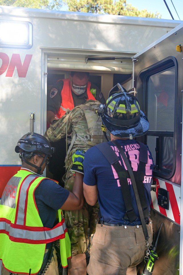A Fort Jackson, South Carolina, firefighter and first responder help load a mock injured trainee into an ambulance before he was delivered to a local medical treatment facility Oct. 19, 2021. The group were participating in an annual, graded...