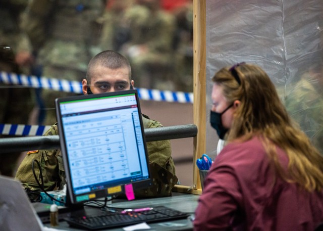 Trainees with Company B, 795th Military Police Battalion, finalize travel itineraries with family and friends and purchase bus and airline tickets Wednesday at Davidson Fitness Center for the annual Holiday Block Leave. Thousands of Soldiers,...