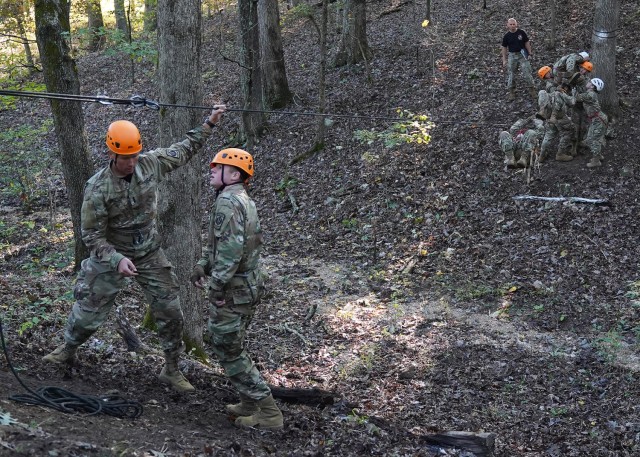 Junior ROTC cadets work to complete the one-rope bridge event Saturday during Raider Challenge.