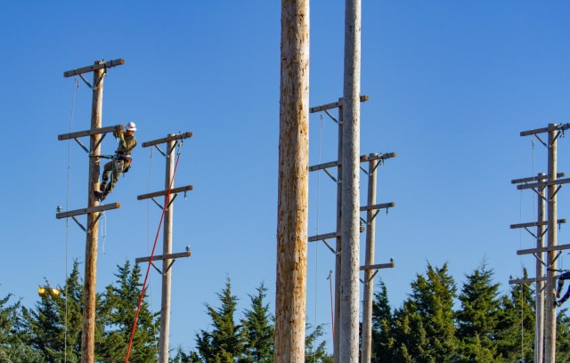 A Soldier from the 249th Engineer Battalion, Prime Power, competes in the Apprentice Pole Climb Obstacle Course during the International Lineman's Rodeo alongside industry professionals at the National Agricultural Center and Hall of Fame in...