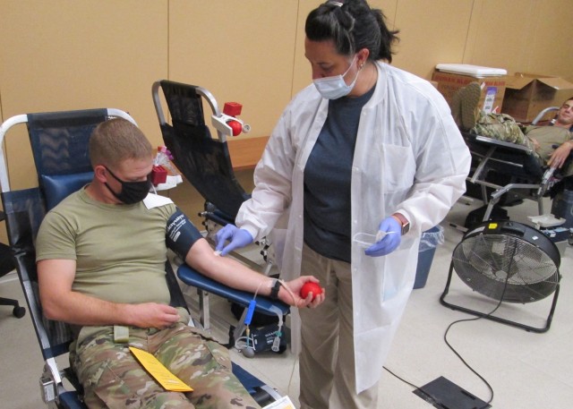 Alannaruth Davis, Fort Leonard Wood Blood Donor Center phlebotomist, prepares Capt. Cody Loose, 595th Sapper Company commander, to donate blood at the 5th Engineer Battalion’s record-setting drive Sept. 29.