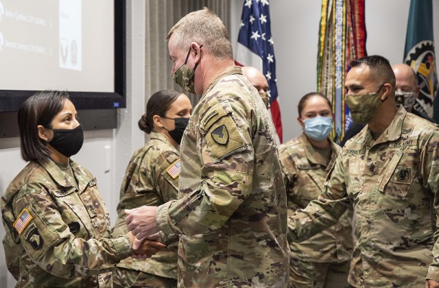 Maj. Gen. Chris Mohan, commanding general, U.S. Army Sustainment Command, congratulates Master Sgt. Maria Fisher, operations noncommissioned officer, G-3 (Operations) Oct. 20 with a Coin of Excellence for her role in facilitating the Senior Leader...