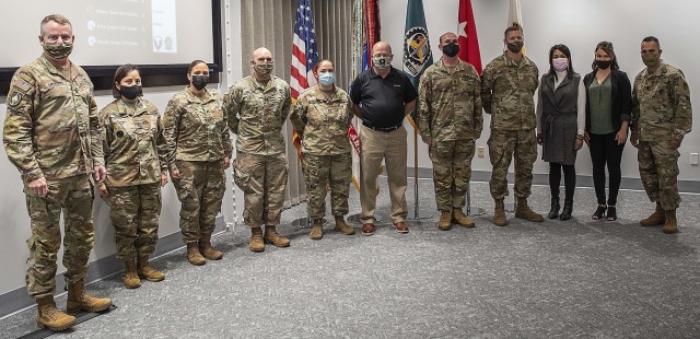 Maj. Gen. Chris Mohan, commanding general, U.S. Army Sustainment Command (left), and ASC Command Sgt. Maj. Marco Torres (right), gather for a photo Oct. 20 with ASC headquarters personnel who received Coins of Excellence for their involvement in...