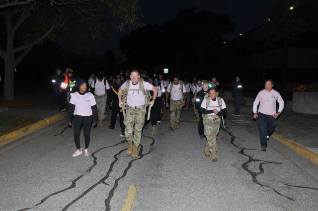 Maj. Gen. Darren Werner (center), commanding general U.S. Army Tank-automotive and Armaments Command, Jacqueline “Jack” Howard (left), Detroit Arsenal Breast Cancer Awareness Month guest speaker, and Master Sgt. Fransheska Wiggins (2nd from right), one of the event coordinators, led the Ruck/Walk/Run at the Detroit Arsenal, Michigan Oct. 18. (Photo by Ted Beupre)