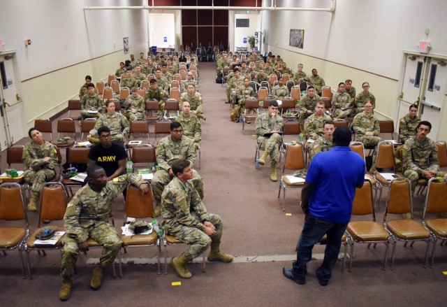 Charles Lyons, a service specialist with the Presidio of Monterey Army Community Service, speaks to service members during the “Help Me Plan a Smooth PCS Move” briefing at the Tin Barn, PoM, Calif., Oct. 20.