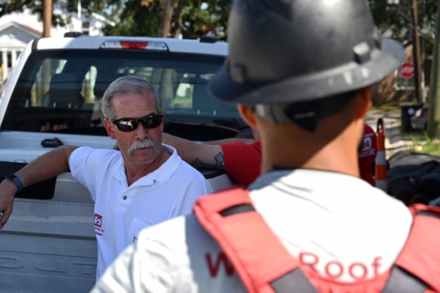 Keith McMullen, left, U.S. Army Corps of Engineers, St. Louis District regulatory supervisor and Hurricane Ida Operation Blue Roof action officer, discusses temporary roof repairs with a contractor in New Orleans Oct. 19. To date, the St. Louis...