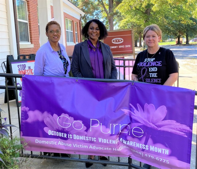 Domestic Victim Advocates Terri Ceaser, left, and Heide Lenning, right, pose with Patricia Harper, Family Advocacy Program manager, outside the entrance of the Army Community Service facility on Mahone Avenue, building 9023. FAP offers a variety...