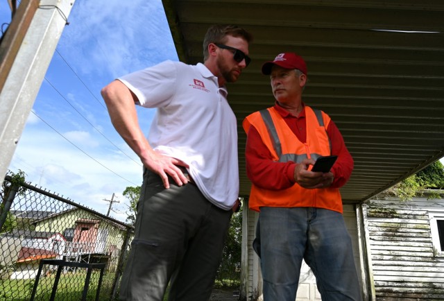Tony Jones, left, U.S. Army Corps of Engineers, St. Louis District construction chief and Hurricane Ida Operation resident engineer, discusses temporary roof repairs with Brenton Rick Hart, U.S. Army Corps of Engineers, Galveston District...