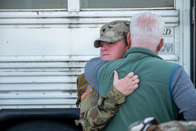 A Soldier assigned to the 142nd Medical Company hugs a loved one at the Army Aviation Support Facility in Windsor Locks, Conn. on Oct. 24, 2021. The unit was mobilizing in support of Operation Atlantic Resolve and heading to Texas before deploying...