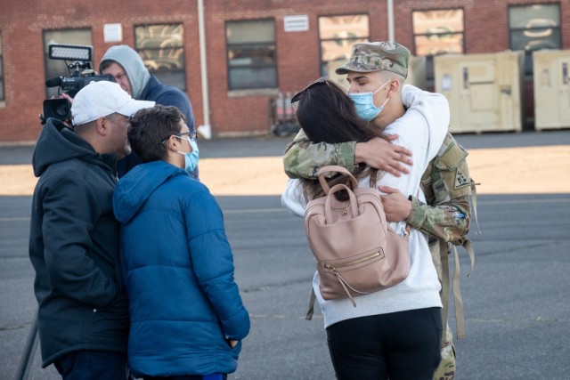 A Soldier assigned to the 142nd Medical Company kisses a loved one at the Army Aviation Support Facility in Windsor Locks, Conn. on Oct. 24, 2021. The unit was mobilizing in support of Operation Atlantic Resolve and heading to Texas before deploying to Poland.