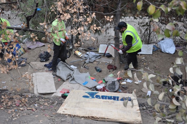 Workers remove trash from an abandoned homeless encampment, Sept. 27, 2021, near Whittier, California, as part of a two-week cleanup by the U.S. Army Corps of Engineers Los Angeles District. About 120 acres of creek and riverbank were cleared...