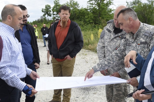 U.S. Army Corps of Engineers, Europe District Southern Europe Area Engineer Bryce Jones, left, provides an overview of ongoing and upcoming construction projects to members of the Bulgarian Air Force at Graf Ignatievo Air Base in Bulgaria June 16, 2021. Jones was recognized as the U.S. Army Corps of Engineers Administrative Contracting Officer of the Year during a virtual ceremony October 25, 2021 for his work in support of the U.S. Army Corps of Engineers missions in Bulgaria as well as several other Southern European countries. (U.S. Army photo by Alfredo Barraza)