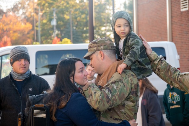 Specialist Joseph Montenegro bids farewell to his wife and child at the Army Aviation Support Facility in Windsor Locks, Conn. on Oct. 24, 2021. His unit, the 142nd Medical Company, was mobilizing in support of Operation Atlantic Resolve and...