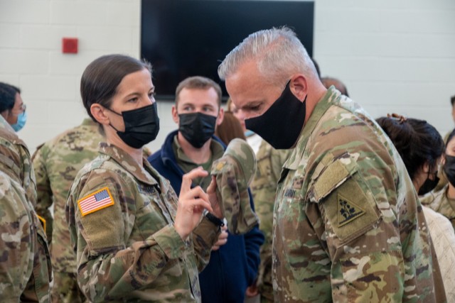 Major Amanda Griffiths and 1st Sgt. Dan Grenier have a conversation at the Army Aviation Support Facility in Windsor Locks, Conn. on Oct. 24, 2021. Their unit, the 142nd Medical Company, was mobilizing in support of Operation Atlantic Resolve and...