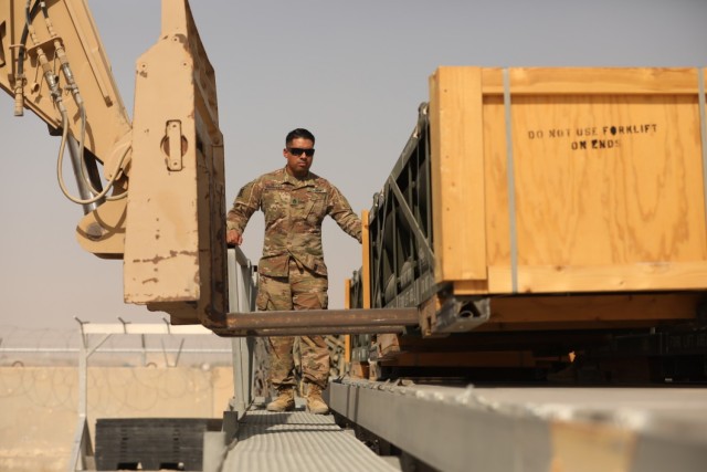 U.S. Army Reserve Staff Sgt. Marcos L. Benavides, an ammunition specialist assigned to the Los Angeles, Calif., based 311th Expeditionary Sustainment Command, watches as a forklift picks up a pallet of Patriot missiles at Ali Al Salem Air Base, Kuwait, on Oct. 11, 2021. The Soldier is preparing to redeploy after a tour spent supporting the 3rd Infantry Division Sustainment Brigade, 1st Theater Sustainment Command. (U.S. Army photo by Spc. Elorina Santos)
