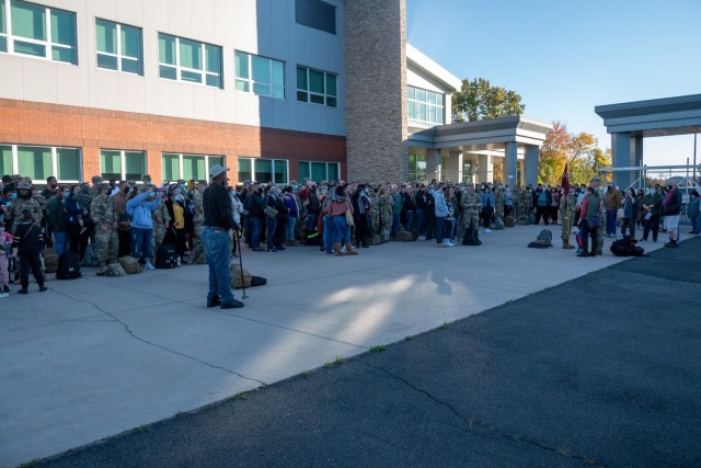 Soldiers assigned to the 142nd Medical Company and their loved ones stand outside the Army Aviation Support Facility in Windsor Locks, Conn. on Oct. 24, 2021. The unit was mobilizing in support of Operation Atlantic Resolve and heading to Texas before deploying to Poland.