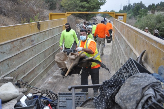 A steady stream of contracted workers fills one of 82 dumpsters used during the San Gabriel River and San Jose Creek cleanup. A total of 575 tons of debris were removed during the two-week project. The U.S. Army Corps of Engineers Los Angeles...