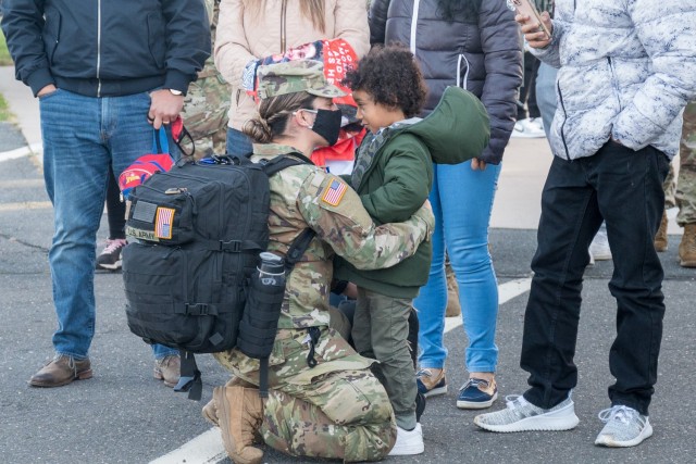 Specialist Marcela Alzate hugs a loved one at the Army Aviation Support Facility in Windsor Locks, Conn. on Oct. 24, 2021. Her unit, the 142nd Medical Company, was mobilizing in support of Operation Atlantic Resolve and heading to Texas before deploying to Poland.
