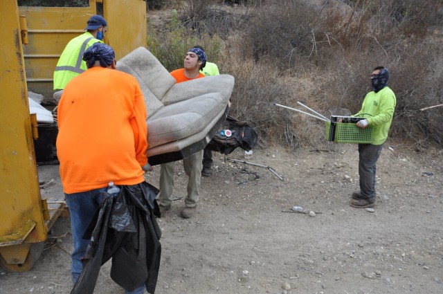 Workers queue-up to dump car seats and other debris found used during the San Gabriel River and San Jose Creek cleanup into one of 82 dumpsters, Sept. 27-Oct. 22, 2021. A total of 575 tons of debris were removed during the two-week project. The...