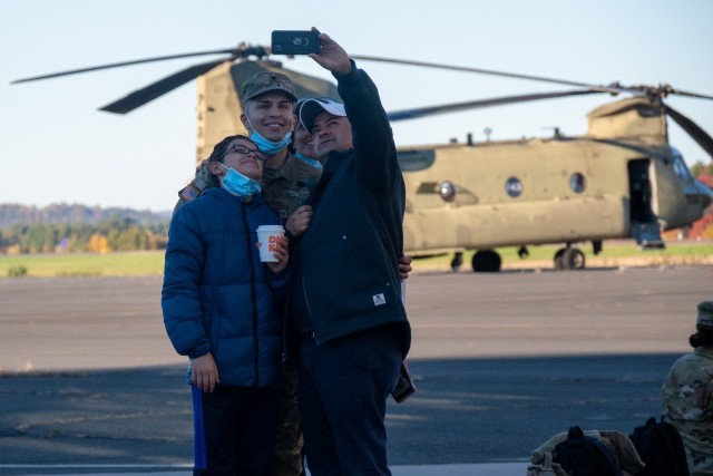 A Soldier assigned to the 142nd Medical Company poses for a picture with his family at the Army Aviation Support Facility in Windsor Locks, Conn. on Oct. 24, 2021. The unit was mobilizing in support of Operation Atlantic Resolve and heading to Texas before deploying to Poland.