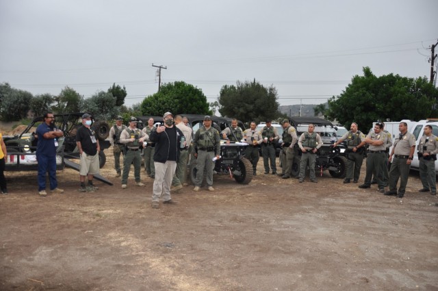 U.S. Army Corps of Engineers Los Angeles District project manager Trevor Snyder, foreground, briefs an early morning assembly of law enforcement, social services and community partners before the start of the two-week project, Sept. 27, in...