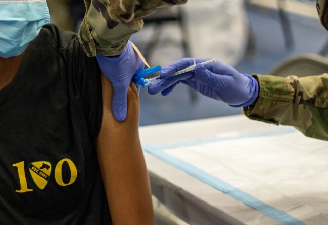 A Trooper from 1st Cavalry Division received COVID Shot during a COVID Vaccine rodeo Oct. 1 at Fort Hood Texas. For the past few months medical professionals within the division have been hosting vaccination drives to increase the number of vaccinated Troopers.