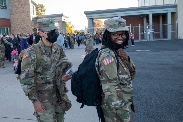 Sergeant Kelle Kennerly walks to a bus outside of the Army Aviation Support Facility in Windsor Locks, Conn. on Oct. 24, 2021. Her unit, the 142nd Medical Company was mobilizing in support of Operation Atlantic Resolve and heading to Texas before deploying to Poland.