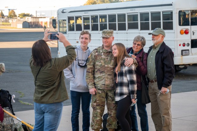 Platoon Sergeant, Sgt. 1st Class Doug Kohlun poses with his family for a picture at the Army Aviation Support Facility in Windsor Locks, Conn. on Oct. 24, 2021. His unit, the 142nd Medical Company, was mobilizing in support of Operation Atlantic...