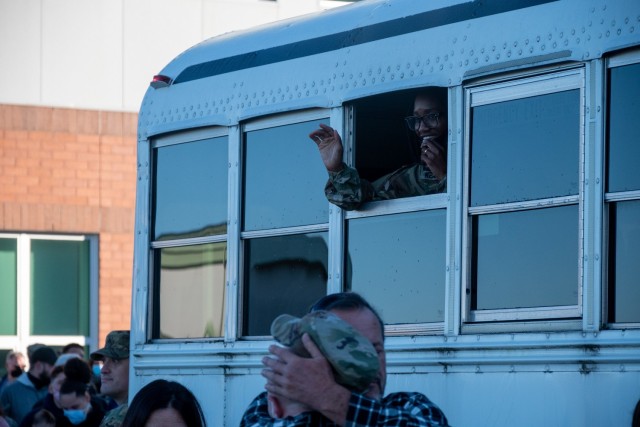 Sergeant Kelle Kennerly waves to loved ones on a bus outside the Army Aviation Support Facility in Windsor Locks, Conn. on Oct. 24, 2021. Her unit, the 142nd Medical Company was mobilizing in support of Operation Atlantic Resolve and heading to...