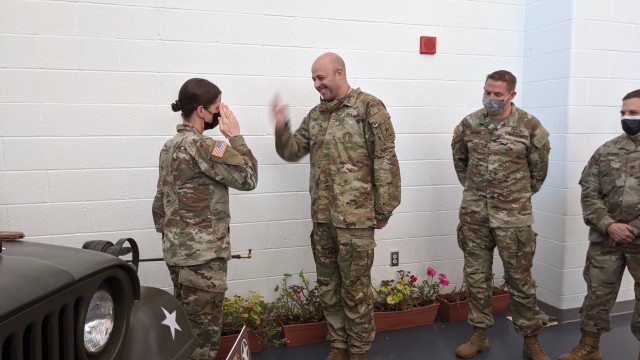 U.S. Army Maj. Shawn Pyer, former commander of the 142nd Medical Company, presents a riding crop that belonged to Lt. Col. Michael Myslinski, the unit's first commander after reconstitution, to the current commander, Maj. Amanda Griffiths at the Army Aviation Support Facility in Windsor Locks, Conn. on Oct. 24, 2021. The unit was mobilizing in support of Operation Atlantic Resolve and heading to Texas before deploying to Poland. The riding crop was used by Myslinski as a prop in an unofficial command photo.