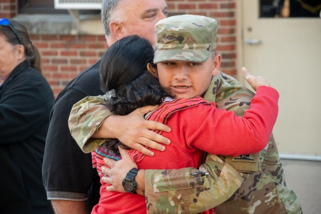 A Soldier assigned to the 142nd Medical Company hugs a loved one at the Army Aviation Support Facility in Windsor Locks, Conn. on Oct. 24, 2021. The unit was mobilizing in support of Operation Atlantic Resolve and heading to Texas before deploying to Poland.