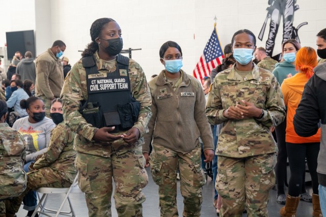 (From left to right) Sergeant Lucinda Thomas and Spc. Olivia Beckford, both former members of the 142nd Medical Company wait with Cpl. Jamonia Mercurius at the Army Aviation Support Facility in Windsor Locks, Conn. on Oct. 24, 2021. The 142nd Medical Company, was mobilizing in support of Operation Atlantic Resolve and heading to Texas before deploying to Poland.