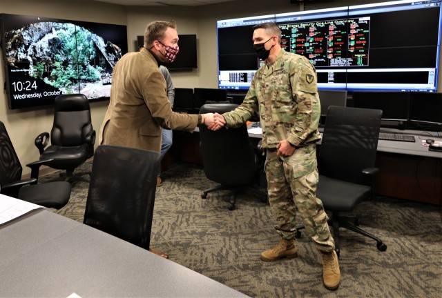 Fort Knox Garrison Commander Lance O’Bryan meets with Kentucky Deputy State Director for Senator Mitch McConnell, Andrew Condia, during the installation’s first full working-day energy test on Oct. 27, 2021.