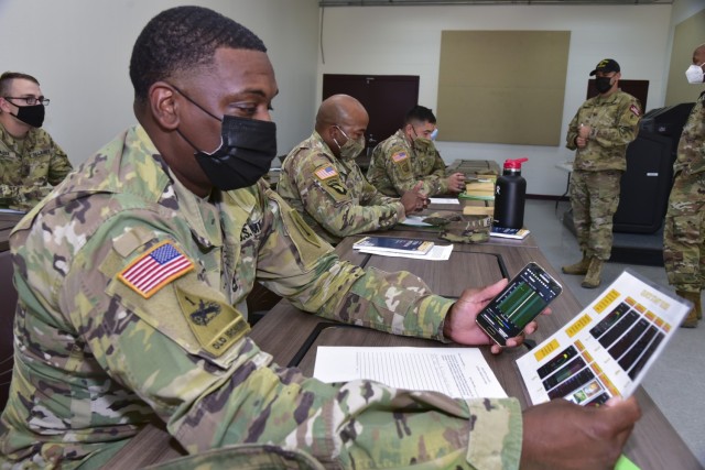 Soldiers assess the Heat Strain Decision Aid (HSDA) and Mental Acuity/2B ALERT app on a smart phone at Camp Bullis, TX.