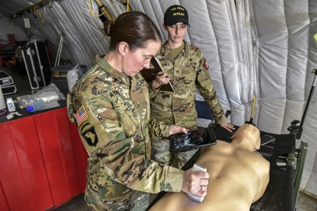 Maj. Mary Ayres, a Family Nurse Practitioner at the Brooke Army Medical Center, tests one of the four Ultrasound Field Portable devices while Staff Sgt. Tara Laramee, a test officer with the U.S. Army Medical Test and Evaluation Activity, observes.