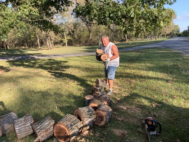 Kevin James, Volunteer at Rocky Point Campgroung on Fort Gibson Lake. Assisting with the cleanup of a fallen tree in the campgrund. Wood is piled up for campers to use.