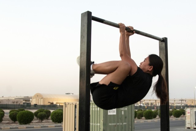 Staff Sgt. Supitcha Wiriyaskunpan, a financial management technician deployed with the Kaiserslautern, Germany, based 266th Finance Support Center, completes a leg tuck at Camp Arifjan, Kuwait, on Oct. 23, 2021. The Bangkok, Thailand, native has gone from not being able to complete one leg tuck to performing ten leg tucks in a row thanks to taking it upon herself to incorporate CrossFit into her routine five days a week during her personal time.