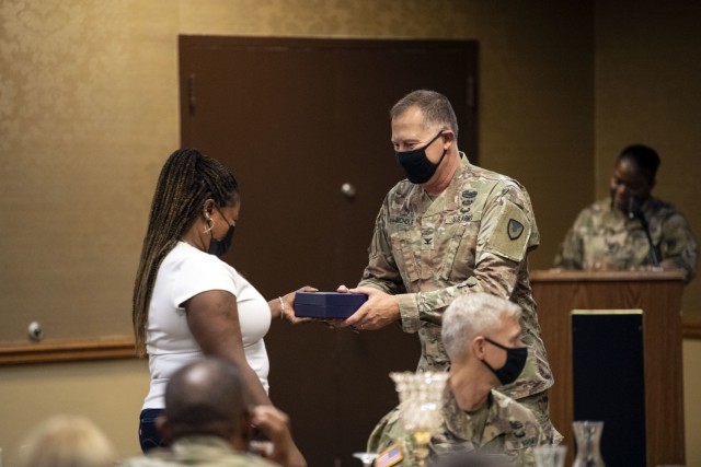 Chaplain (Col.) Jimmy Nichols, Fort Jackson installation chaplain, hands a momento of appreciation to members of the Daniel Circle Choir during the 2021 Ministry/Volunteer Appreciation Luncheon Oct. 22.