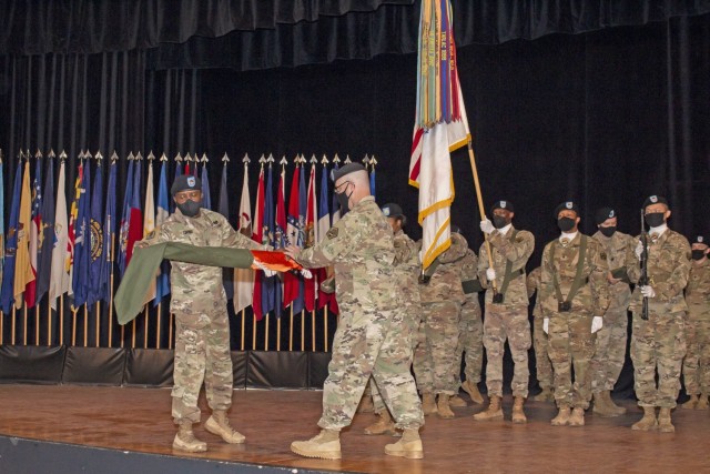Lt. Col. Kevin Weber, commander of the 60th Offensive Cyberspace Operations Signal Battalion (right), and Command Sgt. Maj. Tyrone Cooper uncase the battalion's colors during an activation ceremony for the unit at Fort Gordon, Ga., Oct. 20, 2021. (Photo by Master Sgt. Teddy Wade)