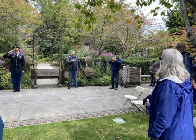 Photo of attendees standing at attention at &#34;Taps&#34;