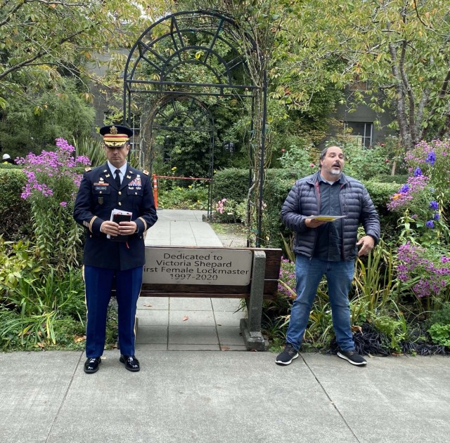Photo of Colonel Bullock and Jonathan Hofstra standing alongside the memorial bench