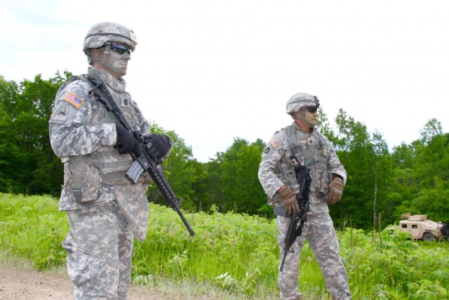 Sgt. Maj. Jeremy Strasser, (left) Operations Sergeant Major, and his brother Command Sgt. Maj. Matthew Strasser, Command Sergeant Major, 1st Squadron,113th Cavalry, 2nd Brigade Combat Team, 34th Infantry Division, Iowa Army National Guard, oversee their cavalry troops in the field during annual training at Camp Ripley, Minn. on June 16, 2017. (U.S. Army National Guard photo by 1st Sgt. Sara Maniscalco Robinson)