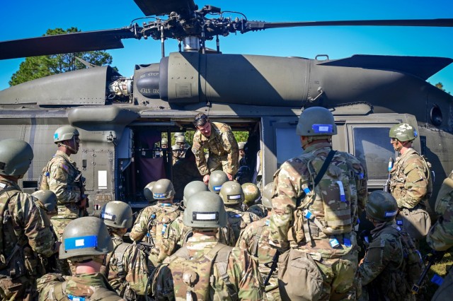 Trainees from 1st Battalion, 34th Infantry Regiment, Fort Jackson, S.C., listen to the medical evacuation crew from Hunter Army Airfield, Savannah, Ga., as they demonstrate how to load and unload a mock injured Soldier from a Black Hawk helicopter Oct. 18, 2021. This is the first, and may be the only time, some of the trainees will be able to get this training during their military careers.