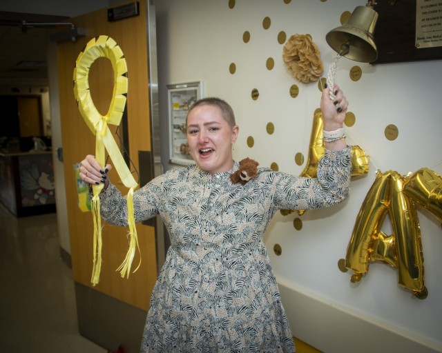 Air Force Airman 1st Class Chelsea Kernan, security forces specialist, rings the Pediatric Hematology/Oncology Clinic bell, signaling the end of her cancer treatment at Brooke Army Medical Center, Fort Sam Houston, Texas, Oct. 15, 2021. Kernan, originally from Smithton, Illinois, had been battling Ewing’s Sarcoma, a rare type of cancer that occurs in bones or in the soft tissue around the bones. (U.S. Army photo by Jason W. Edwards)