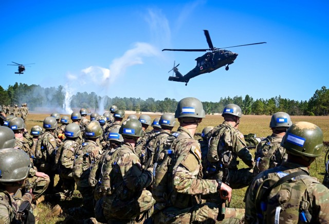 Trainees assigned to 1st Battalion, 34th Infantry Regiment, Fort Jackson, S.C., kneel as the await a UH-60 Black Hawk helicopter land Oct. 18, 2021. Two helicopters and flight crews assigned to the 2nd Battalion, 3rd General Support Aviation Battalion “Dust-off,” from Hunter Army Airfield located in Savannah, Ga., flew to the installation to help teach the trainees to load and unload a patient from the aircraft. Each team of trainees practiced their skills as the helicopters took off and returned to the landing zone marked by white smoke and orange flags staked into the ground to provide real-world experience during the training event.