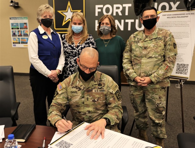 Commanding General of U.S. Army Cadet Command and Fort Knox Maj. Gen. Johnny Davis signs his newly established wellness philosophy proclamation Oct. 28, 2021.