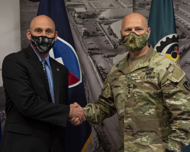 Gen. Ed Daly, commanding general of the U.S. Army Materiel Command, congratulates Rick Murphy after presenting him with a commander’s coin for his work on a lease for facilities at Subic Bay in the Philippines. Daly made the presentation during...
